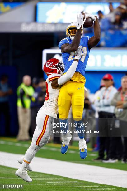 Mike Williams of the Los Angeles Chargers catches a pass while defended by L'Jarius Sneed of the Kansas City Chiefs during the first quarter at SoFi...