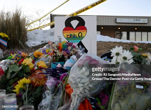 People leaves flowers and other items at a memorial near Club Q where a 22-year-old gunman entered an LGBTQ nightclub killing at least five people...