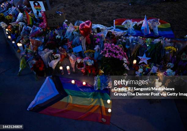People leaves flowers and other items at a memorial near Club Q where a 22-year-old gunman entered an LGBTQ nightclub killing at least five people...