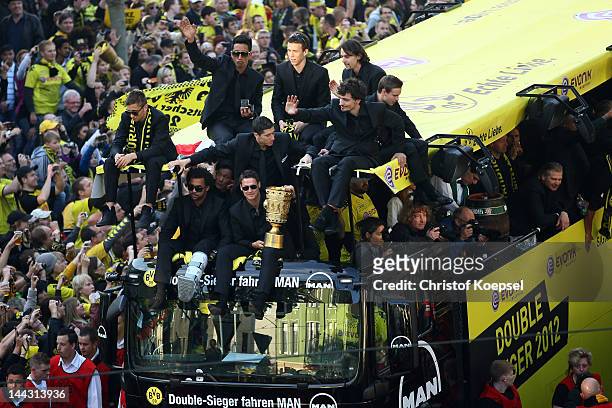 Sebastian Kehl holds the DFB tropy and celebrates with his team during a parade at Borsigplatz celebrating Borussia Dortmund's Bundesliga and DFB Cup...