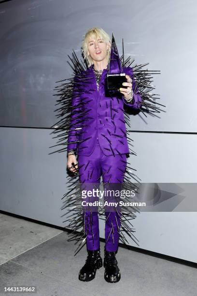 Machine Gun Kelly, winner of the Favorite Rock Artist award, poses in the press room during the 2022 American Music Awards at Microsoft Theater on...