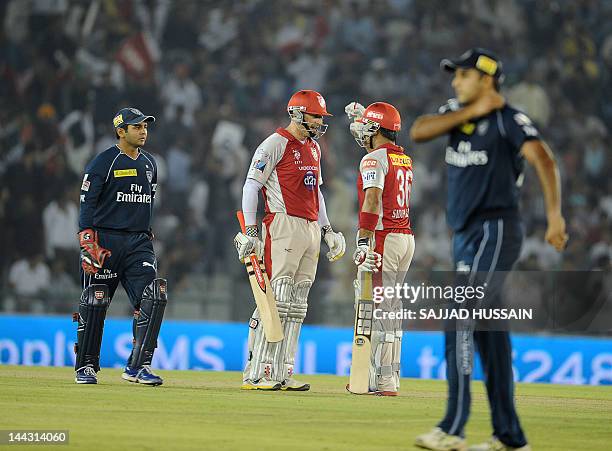 Kings XI Punjab batsman David Hussey talks with his teammate Siddharth Chitnis during the IPL Twenty20 cricket match between Kings XI Punjab and...