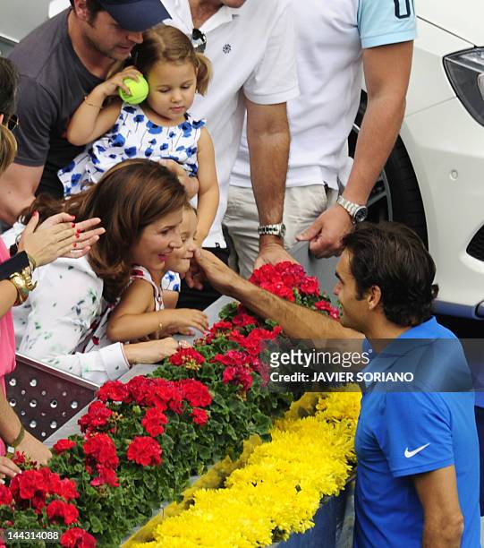 Swiss Roger Federer celebrates with his wife and daughters after winning the final tennis match of the Madrid Masters against Czech Tomas Berdych on...
