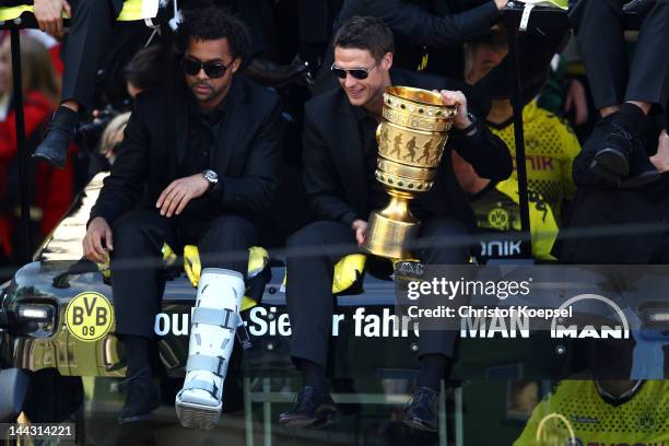 Patrick Owomoyela and Sebastian Kehl sit on the bus with the trophy during a parade at Borsigplatz celebrating Borussia Dortmund's Bundesliga and DFB...