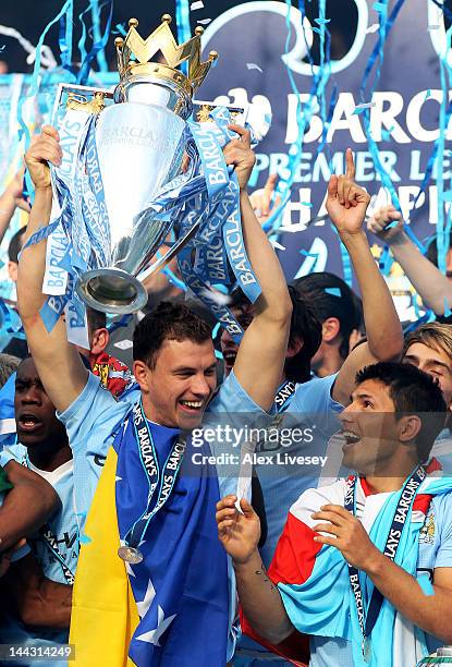 Edin Dzeko and Sergio Aguero of Manchester City celebrate with the trophy following the Barclays Premier League match between Manchester City and...