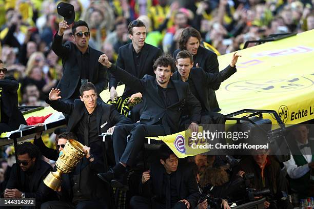 Lucas Barrios, Robert Lewandowski, Ivan Perisic, Mats Hummels, Chris Loewe and Neven Subotic of Dortmund wave to the fans during a parade at...