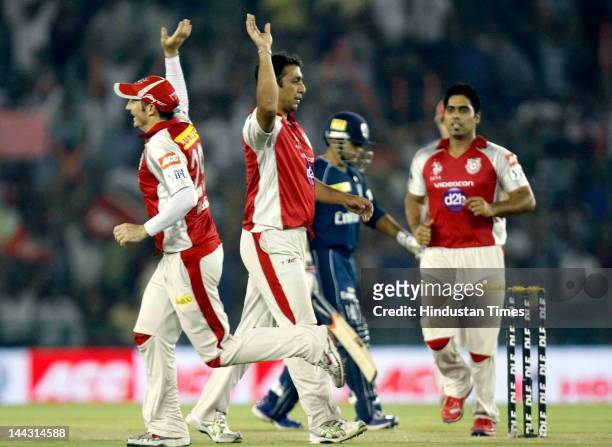 Kings XI Punjab bowler Azhar Mehmood celebrates wih teammates after dismissal of Deccan Chargers batsman Parthiv Patel during the IPL T20 cricket...