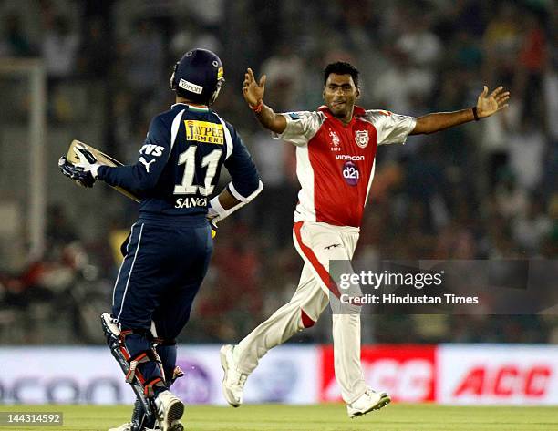 Kings XI Punjab bowler Parvinder Awana celebrates after dismissal of Deccan Chargers captain Kumar Sangakkara during the IPL T20 cricket match played...