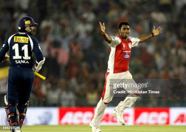 Kings XI Punjab bowler Parvinder Awana celebrates after dismissal of Deccan Chargers captain Kumar Sangakkara during the IPL T20 cricket match played...