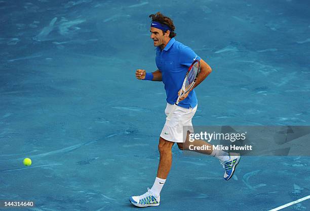 Roger Federer of Switzerland reacts after breaking the serve of Tomas Berdych of Czech Republic in the Men's Single Final on Day Nine of the Mutua...