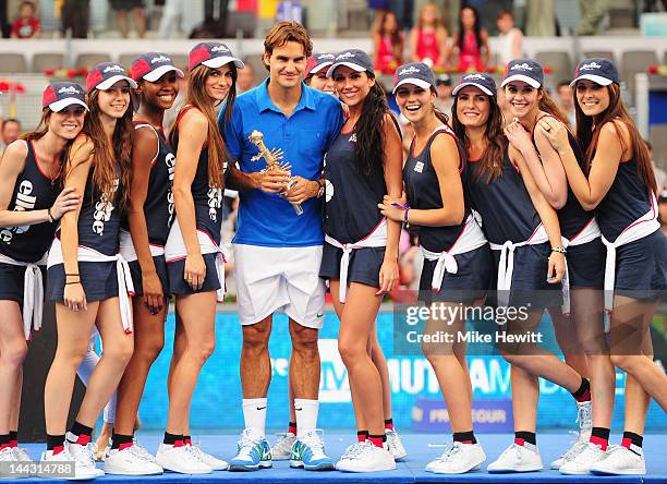 Roger Federer of Switzerland is surrounded by ball girls after his victory over Tomas Berdych of Czech Republic in the Men's Single Final on Day Nine...