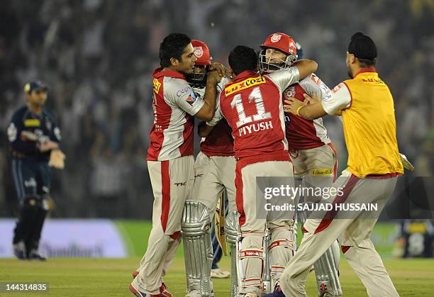 Kings XI Punjab batsman Gurkeerat Singh and teammate David Hussey celebrate with teammates after winning the match against Deccan Chargers during the...