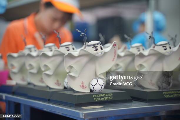 Employee make figurines of the FIFA World Cup Qatar 2022 mascot La'eeb at a factory on November 15, 2022 in Dongguan, Guangdong Province of China.