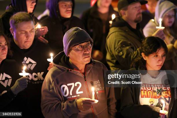 People hold a vigil at a makeshift memorial near the Club Q nightclub on November 20, 2022 in Colorado Springs, Colorado. Yesterday, a 22-year-old...