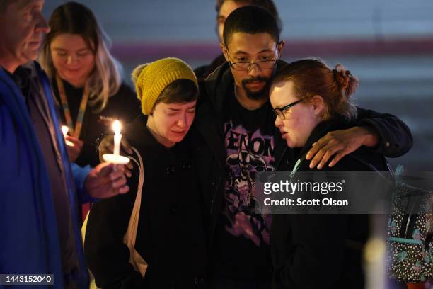 People hold a vigil at a makeshift memorial near the Club Q nightclub on November 20, 2022 in Colorado Springs, Colorado. Yesterday, a 22-year-old...