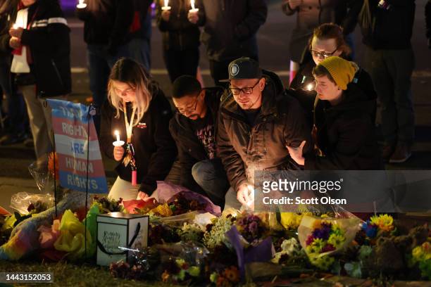 People hold a vigil at a makeshift memorial near the Club Q nightclub on November 20, 2022 in Colorado Springs, Colorado. Yesterday, a 22-year-old...