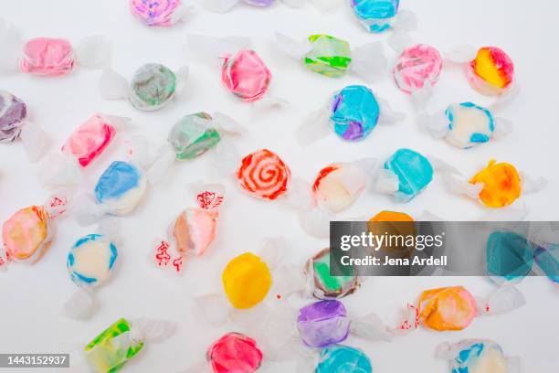 colorful candy background, salt water taffy candies on white background - old fashioned candy stock pictures, royalty-free photos & images