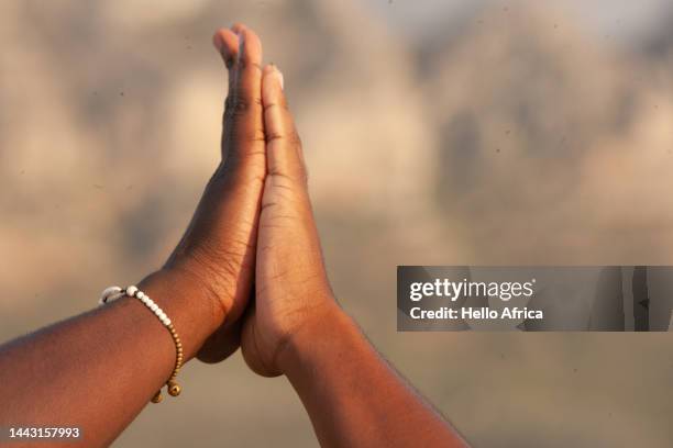 landscape view of high five between friends, a pair of light brown hands in a high five at the moment of touching or a mutual sign & gesture of togetherness between friends - northern european stock pictures, royalty-free photos & images