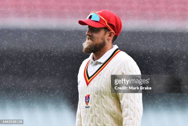 Jake Lehmann of the Redbacks leavrs the ground due to rain during the Sheffield Shield match between South Australia Redbacks and Queensland Bulls at...