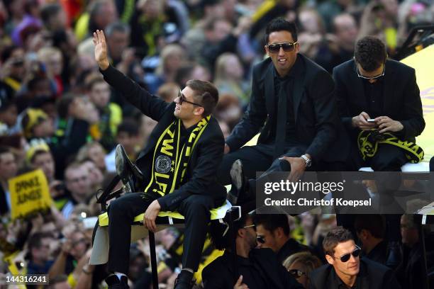 Moritz Leitner, Lucas Barrios and Ivan Perisic of Dortmund celebrate during a parade at Borsigplatz celebrating Borussia Dortmund's Bundesliga and...