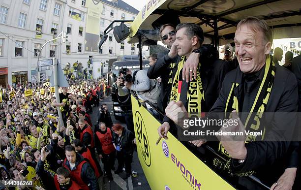 Borussia Dortmund CEO Hans-Joachim Watzke , head coach Juergen Klopp and manager Michael Zorc celebrate during a victory parade on an open top bus...