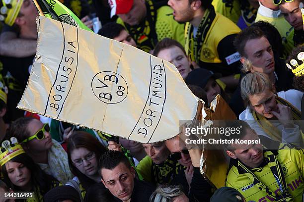 Fans of Dortmund present the trophy during a parade at Borsigplatz celebrating Borussia Dortmund's Bundesliga and DFB Cup win on May 13, 2012 in...