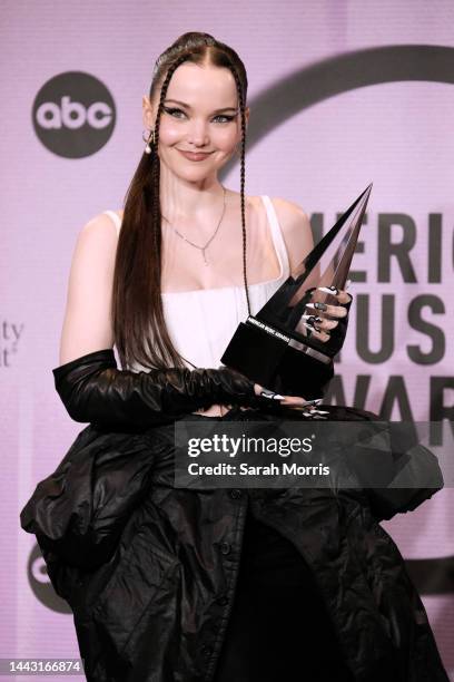 Dove Cameron, winner of the New Artist of the Year award, poses in the press room at the 2022 American Music Awards at Microsoft Theater on November...