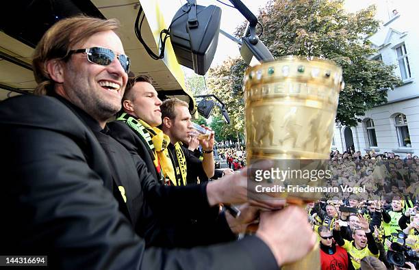 Head coach Juergen Klopp celebrates with the DFB Cup during a victory parade on an open top bus after winning the DFB Cup and Bundesliga Trophy, on...