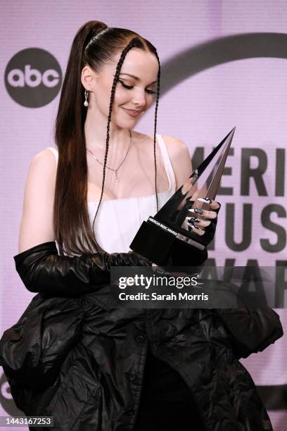 Dove Cameron, winner of the New Artist of the Year award, poses in the press room at the 2022 American Music Awards at Microsoft Theater on November...