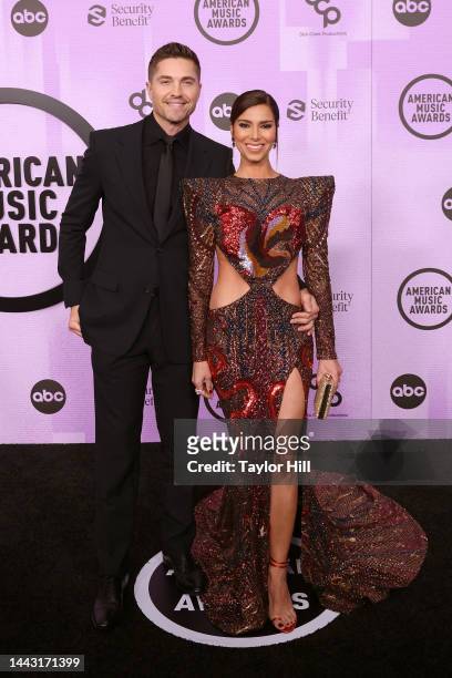 Eric Winter and Roselyn Sanchez attends the 2022 American Music Awards at Microsoft Theater on November 20, 2022 in Los Angeles, California.