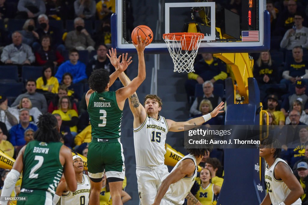 Ben Roderick of the Ohio Bobcats attempts a shot over Joey Baker of ...