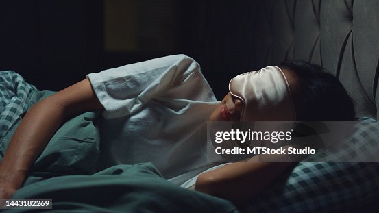 Young beautiful Asia girl lay on bed soft pillow wear eyes mask relaxing from work deep breath sleep tight and well on comfort bed in bedroom cozy home at night. Young beautiful Asia girl lay on bed soft pillow wear eyes mask relaxing from work deep breath sleep tight and well on comfort bed in bedroom cozy home at night.