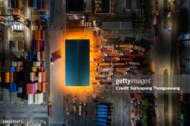 container trucks line up to enter the terminal for unload container to container cargo ship at terminal commercial port, business logistics import export or freight transportation. - elevator bridge - fotografias e filmes do acervo