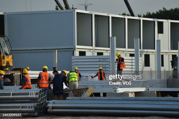 Workers build a makeshift hospital for COVID-19 patients in Tianhe district on November 20, 2022 in Guangzhou, Guangdong Province of China.