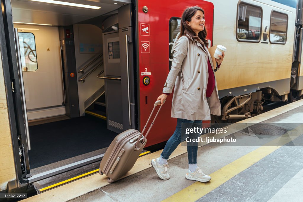 Businesswoman getting off the train
