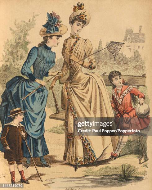 Colour plate from Journal Des Demoiselles showing two young women wearing slim fitting afternoon gowns with tight sleeves and structured bustles, a...