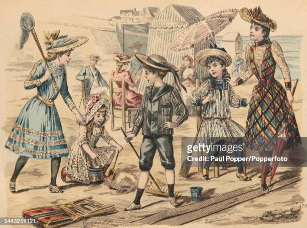 Colour plate from Journal Des Demoiselles showing a group of children playing at the seaside, two older girls wear pale blue and plaid knee length...