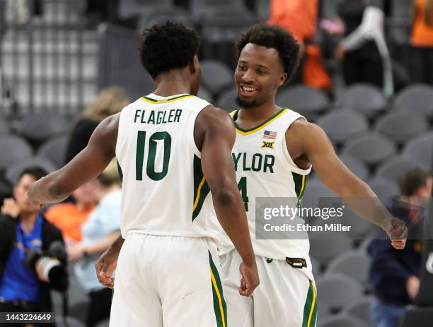 Adam Flagler and LJ Cryer of the Baylor Bears celebrate on the court after their 80-75 victory over the UCLA Bruins during the Continental Tire Main...