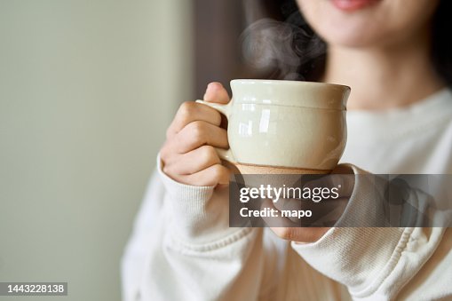 Asian woman relaxing with a drink Asian woman relaxing with a drink