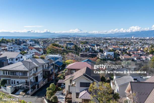 snowcapped mt. fuji and the residential district by the sea in kanagawa of japan - kanagawa prefecture stock pictures, royalty-free photos & images