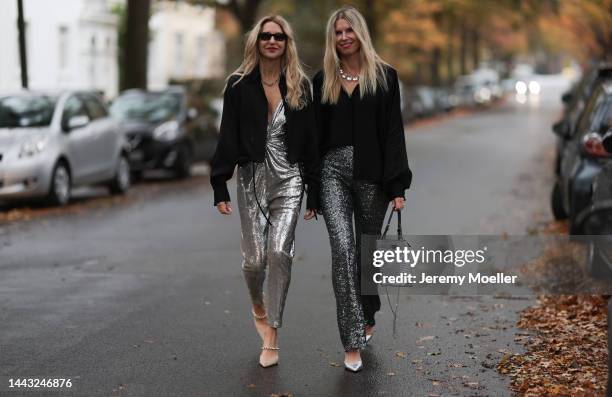 Sue Giers seen wearing SoSUE Blouse Shiny Black, silver Zara heels, Halston silver shiny jumpsuit, Vintage YSL black sunglasses and Antonia seen...