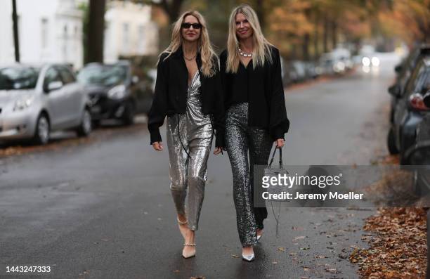 Sue Giers seen wearing SoSUE Blouse Shiny Black, silver Zara heels, Halston silver shiny jumpsuit, Vintage YSL black sunglasses and Vanessa Giers...