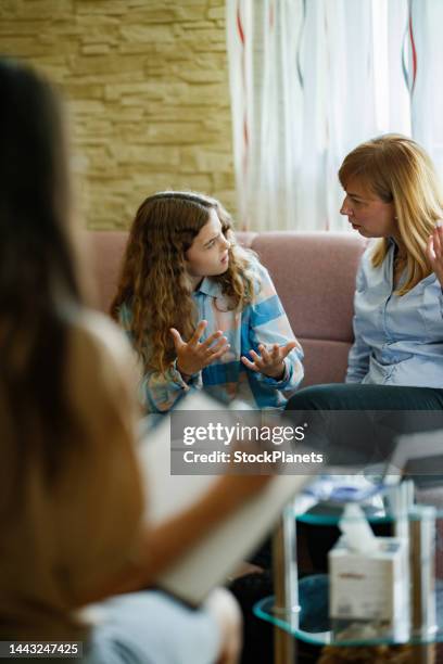 mother and her teenager daughter talking during psychologist's session - child psychologist stock pictures, royalty-free photos & images