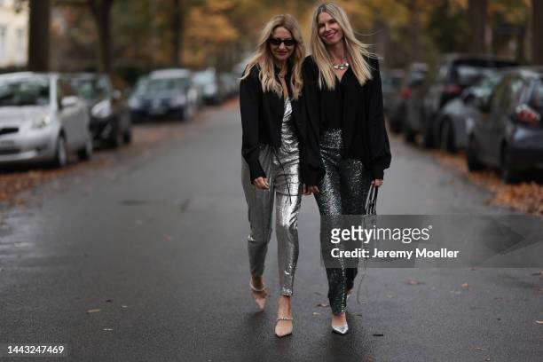 Sue Giers seen wearing SoSUE Blouse Shiny Black, silver Zara heels, Halston silver shiny jumpsuit, Vintage YSL black sunglasses and Vanessa Giers...