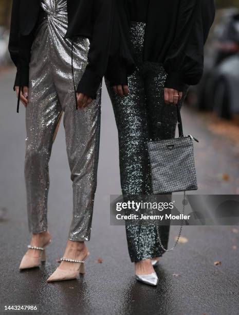 Sue Giers seen wearing SoSUE Blouse Shiny Black, silver Zara heels, Halston silver shiny jumpsuit, Vintage YSL black sunglasses and Vanessa Giers...