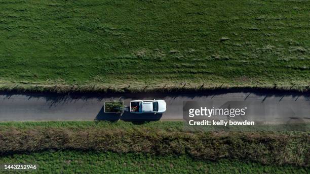 pick up truck car van vehicle transport driving on uk rural country road with trailer drone view - lorry uk photos et images de collection