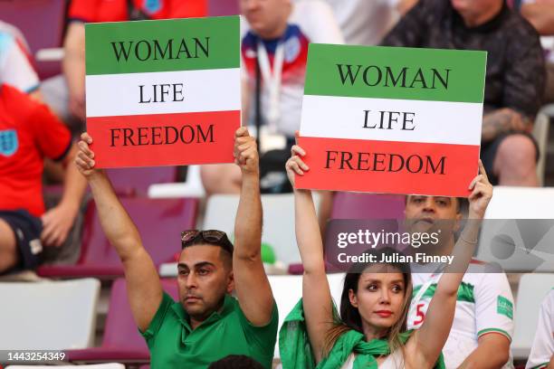 Iranian fans hold up signs advocating for women's rights prior to the FIFA World Cup Qatar 2022 Group B match between England and IR Iran at Khalifa...