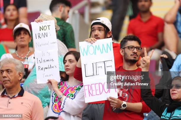 Iranian fans hold up signs advocating for women's rights prior to the FIFA World Cup Qatar 2022 Group B match between England and IR Iran at Khalifa...