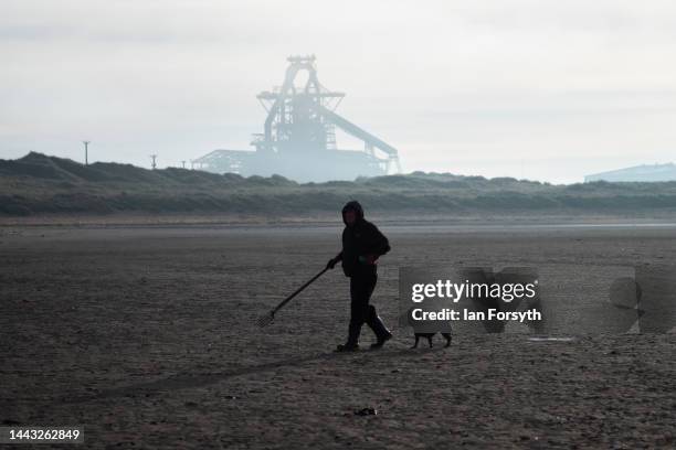 Man digs for fishing bait on the beach in front of the former steel blast furnace near Redcar that is due to be brought down in an explosive...