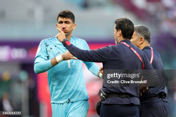 Alireza Beiranvand of IR Iran is attended to by medical staff after sustaining an injury during the FIFA World Cup Qatar 2022 Group B match between...